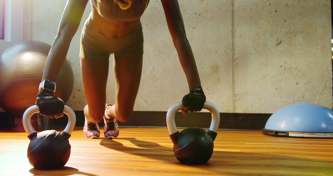 Individual Engaging in Kettlebell Push-up at Modern Gym - Free Images, Stock Photos and Pictures on Pikwizard.com