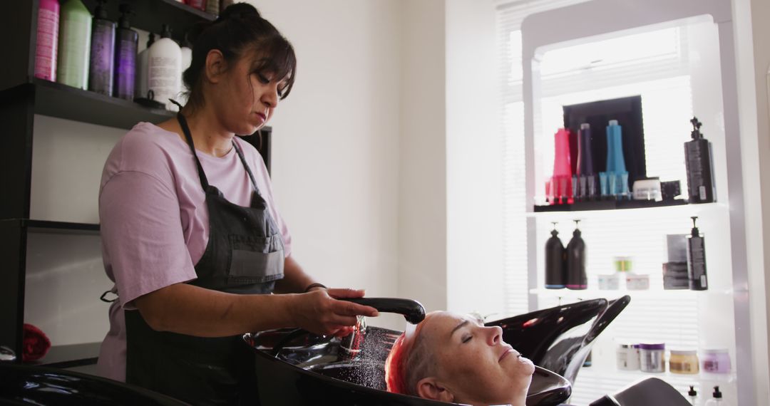 Hairdresser Washing Hair of Mature Woman in Salon - Free Images, Stock Photos and Pictures on Pikwizard.com