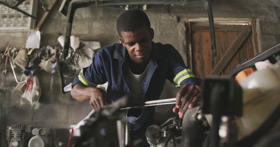 Male Mechanic Working on Car Engine in Workshop - Free Images, Stock Photos and Pictures on Pikwizard.com