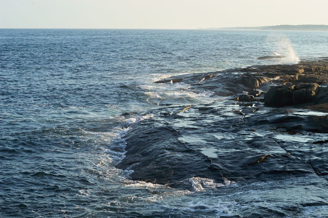 Waves Crashing on Rocky Shoreline at Dawn