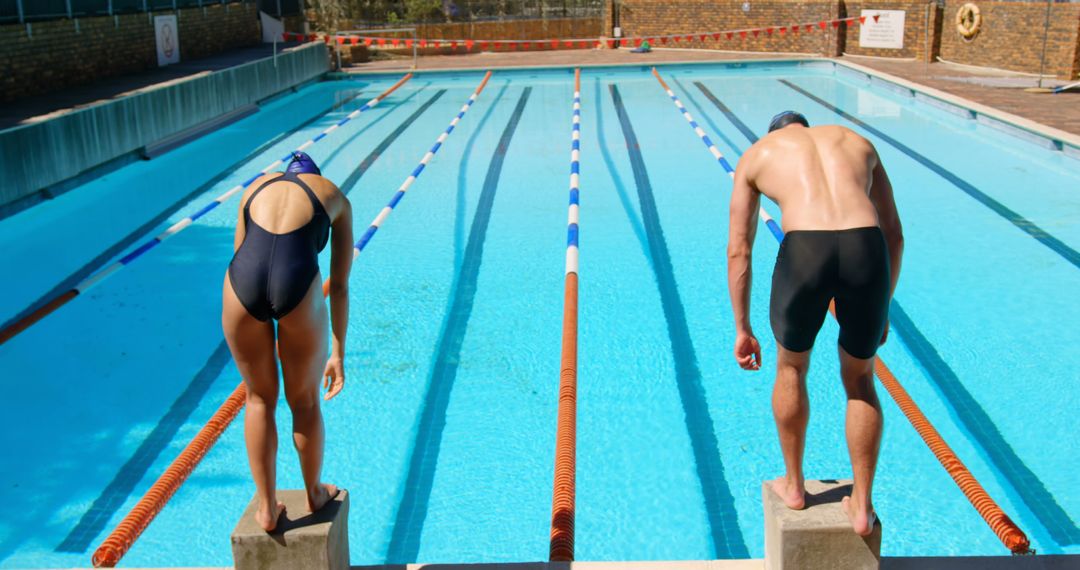 Male and Female Swimmers Preparing to Dive at Outdoor Pool - Free Images, Stock Photos and Pictures on Pikwizard.com