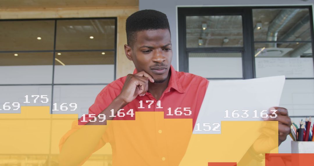 Businessman Analyzing Data Documents in Modern Office