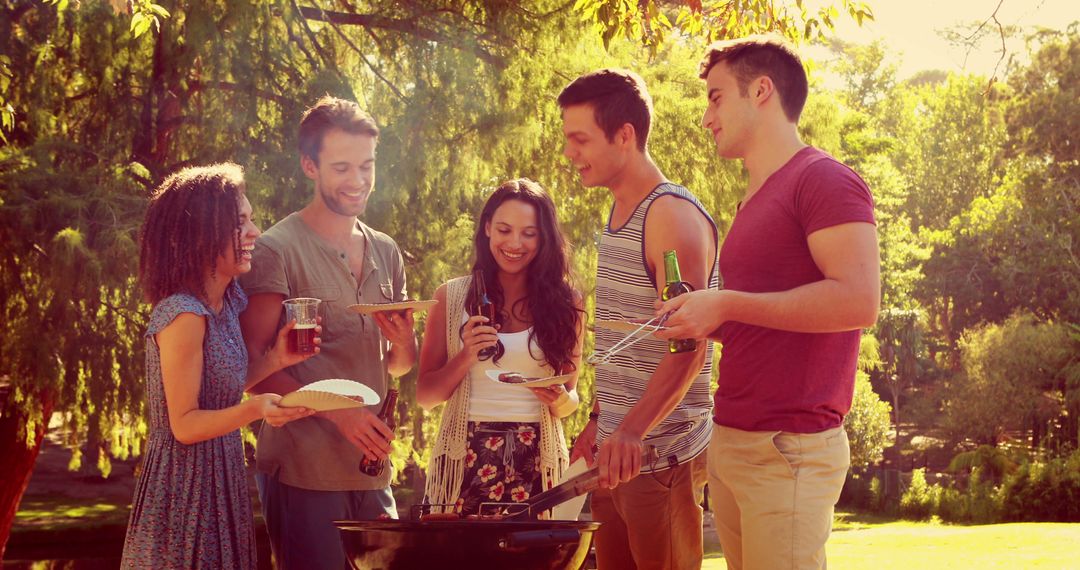 Young Friends Enjoying Outdoor Barbecue in Park - Free Images, Stock Photos and Pictures on Pikwizard.com