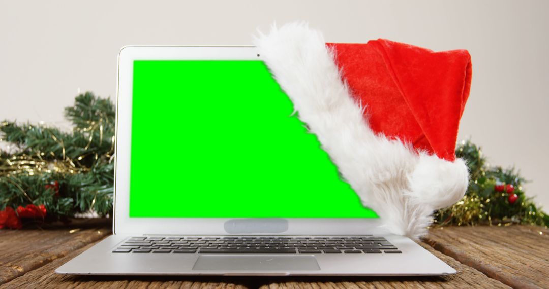 Laptop with Santa Hat and Green Screen for Holiday Themes - Free Images, Stock Photos and Pictures on Pikwizard.com