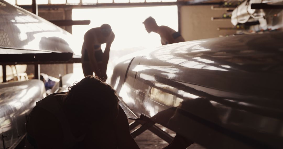 Rowing Team Preparing Boats in Boathouse - Free Images, Stock Photos and Pictures on Pikwizard.com