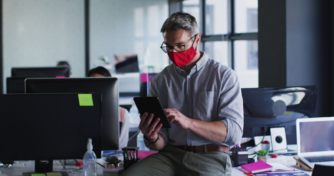 Businessman Wearing Mask Using Tablet in Office - Free Images, Stock Photos and Pictures on Pikwizard.com