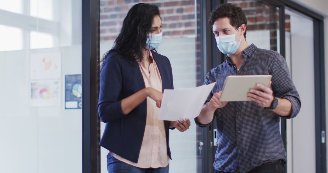 Diverse Coworkers Discussing at Office While Wearing Face Masks