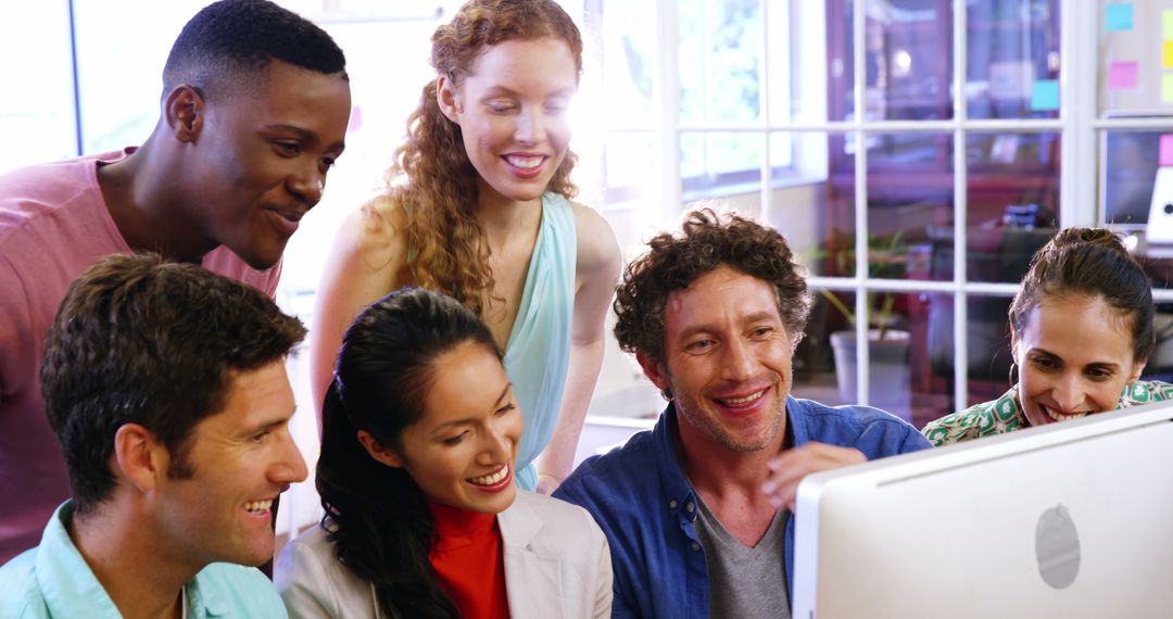 Diverse Office Team Collaborating on Computer Project