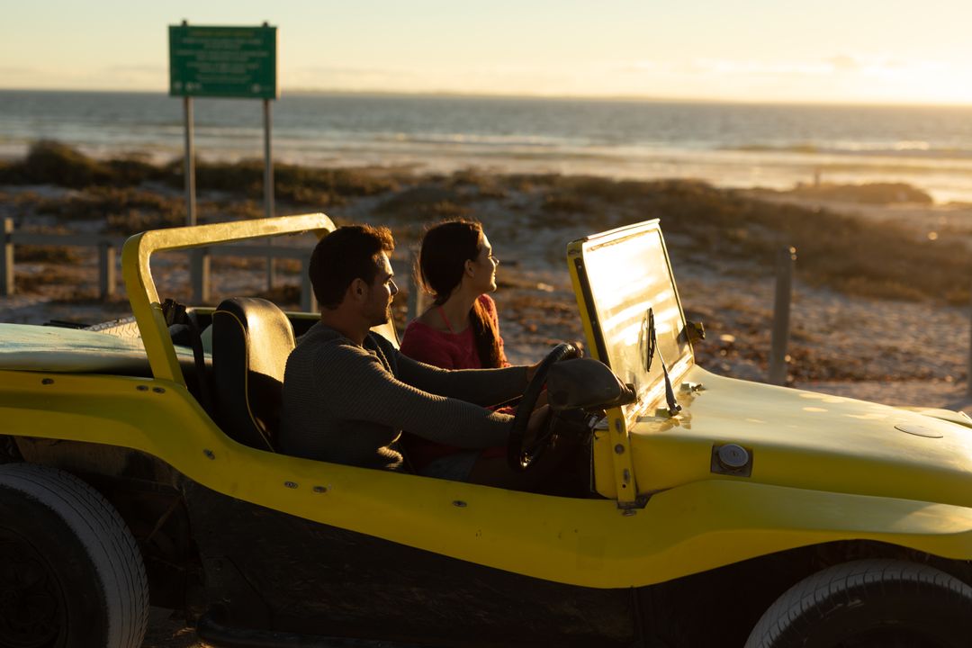 Couple Driving Beach Buggy at Sunset by Sea - Free Images, Stock Photos and Pictures on Pikwizard.com