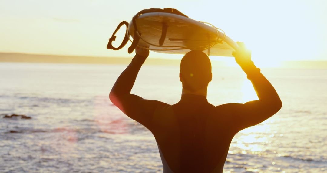 Surfer Holding Surfboard at Sunrise Overlooking Ocean - Free Images, Stock Photos and Pictures on Pikwizard.com