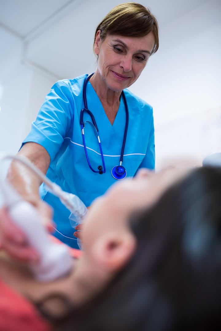 Woman getting ultrasound of a thyroid from doctor - Free Images, Stock Photos and Pictures on Pikwizard.com