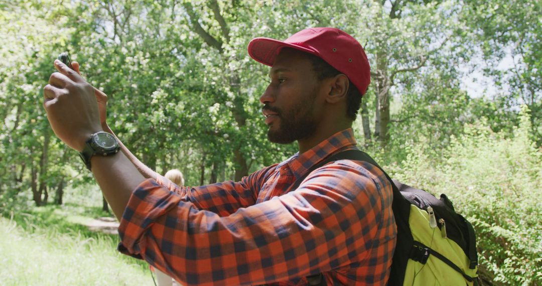 Man capturing nature photography in forest - Free Images, Stock Photos and Pictures on Pikwizard.com