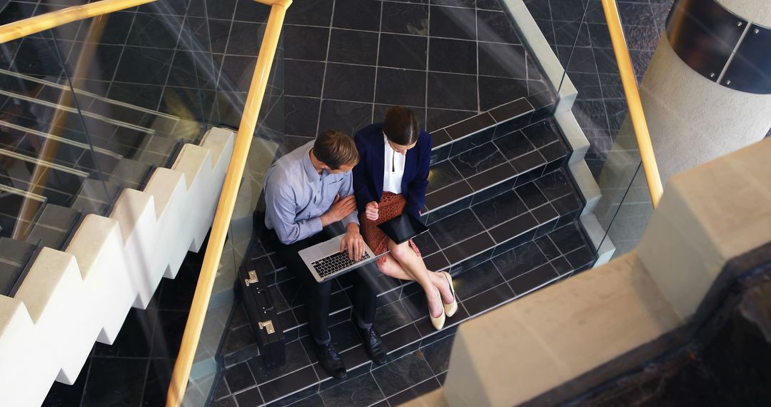 Business Professionals Collaborating on Staircase
