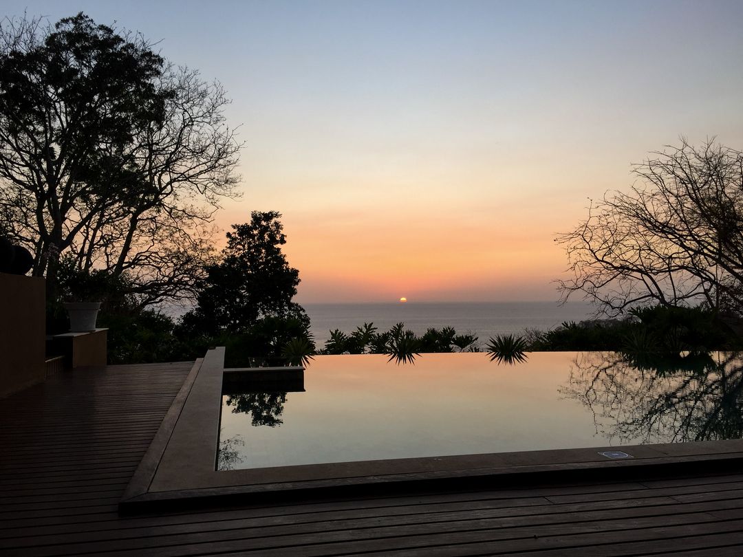 Tranquil Infinity Pool Overlooking Ocean Sunset