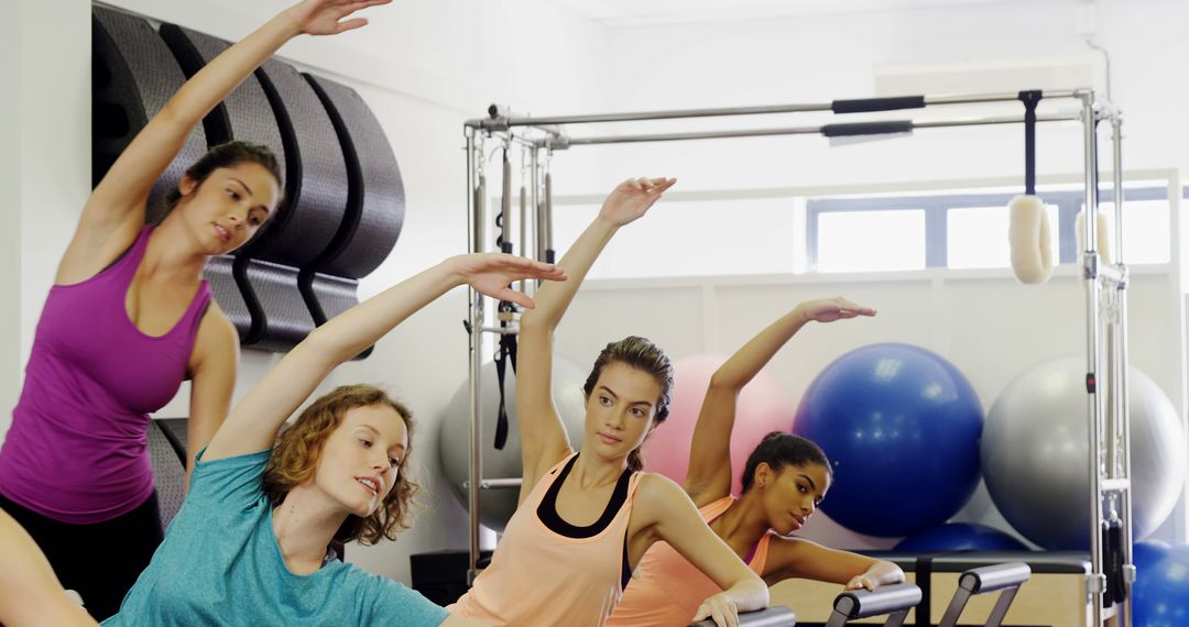 Women Practicing Pilates with Equipment in Fitness Studio - Free Images, Stock Photos and Pictures on Pikwizard.com