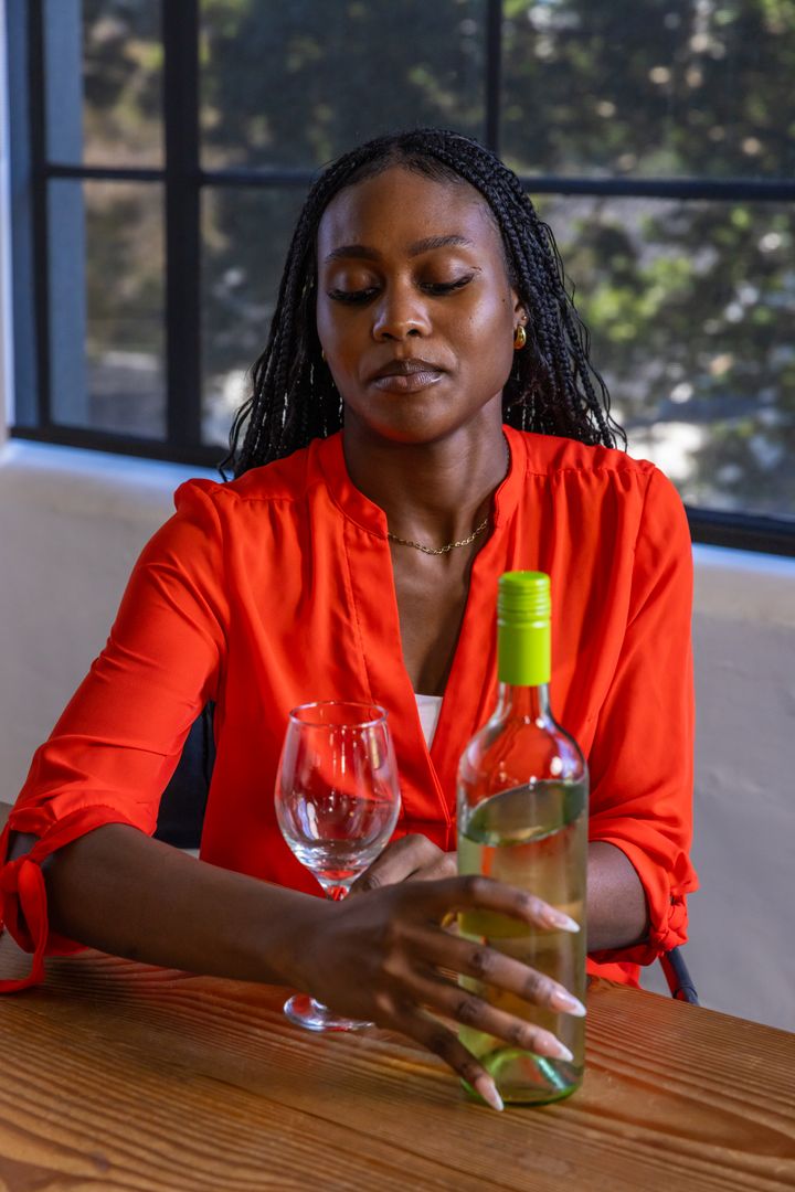 Sophisticated Woman Enjoying White Wine in Modern Setting