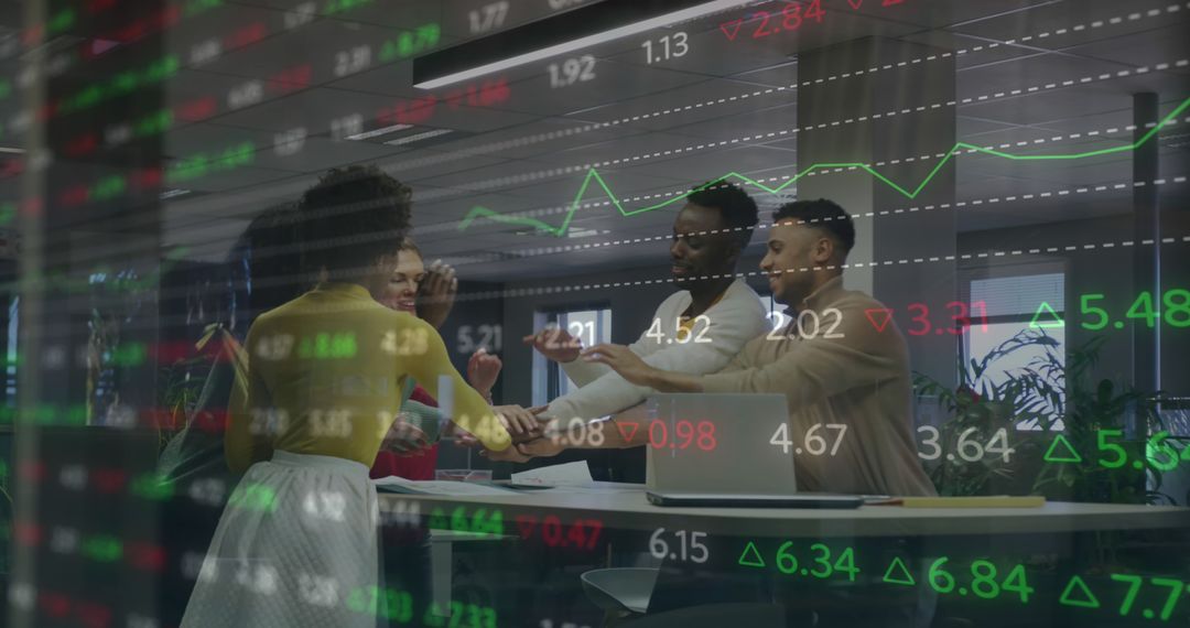 Diverse Business Team Stacking Hands in Front of Stock Market Data