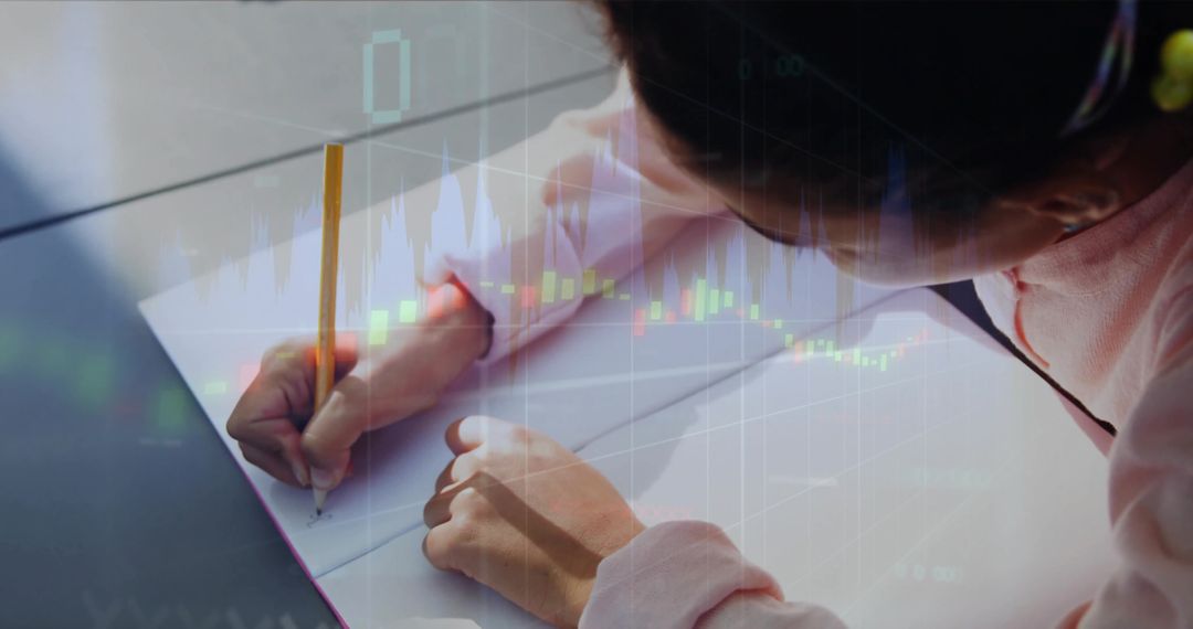 Child writing in spiral notebook with financial chart overlay, studying math and finance
