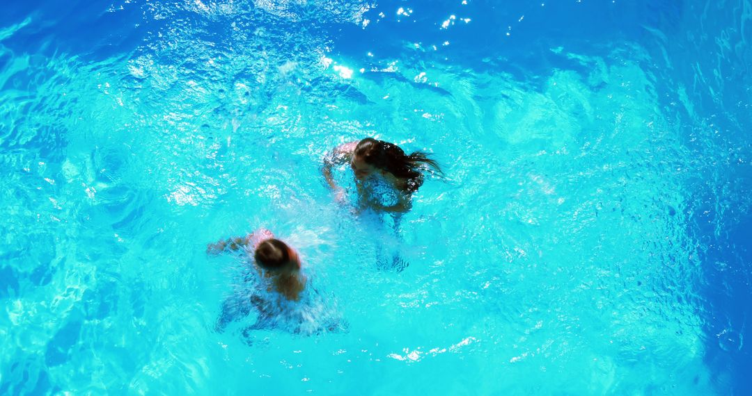 Children Playing in Bright Blue Swimming Pool From Above - Free Images, Stock Photos and Pictures on Pikwizard.com