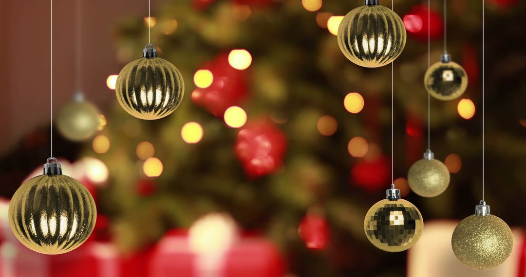 Golden Christmas Baubles on Decorated Tree with Festive Lights