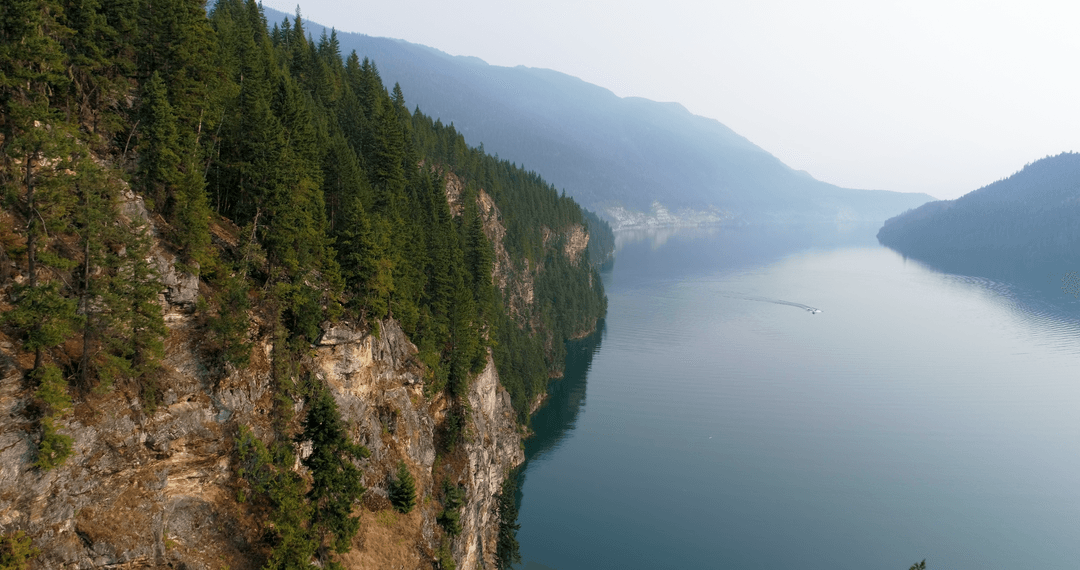 Tranquil Mountain Landscape with Fog and Serene River