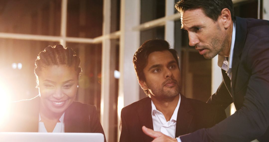 Diverse Business Team Collaborates on Project with Laptop