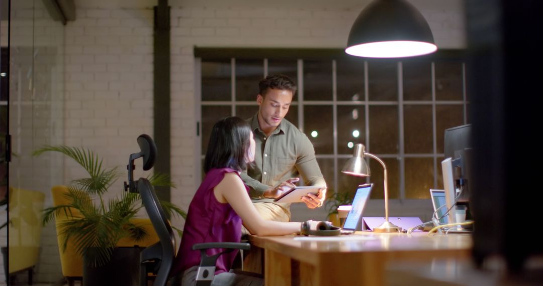 Diverse Team Working Late in Modern Office