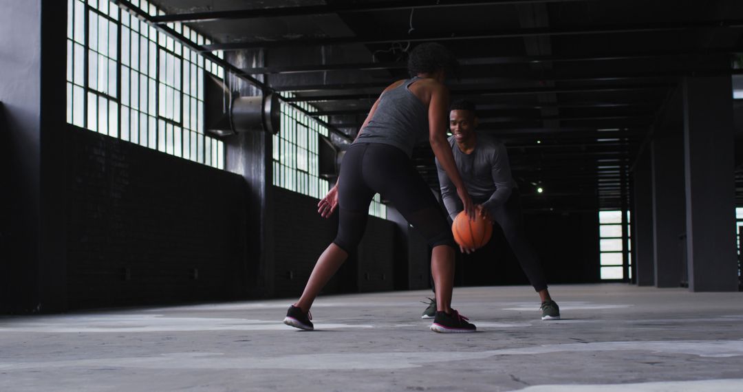 Dynamic Female Athletes Practicing Basketball in Industrial Space - Free Images, Stock Photos and Pictures on Pikwizard.com