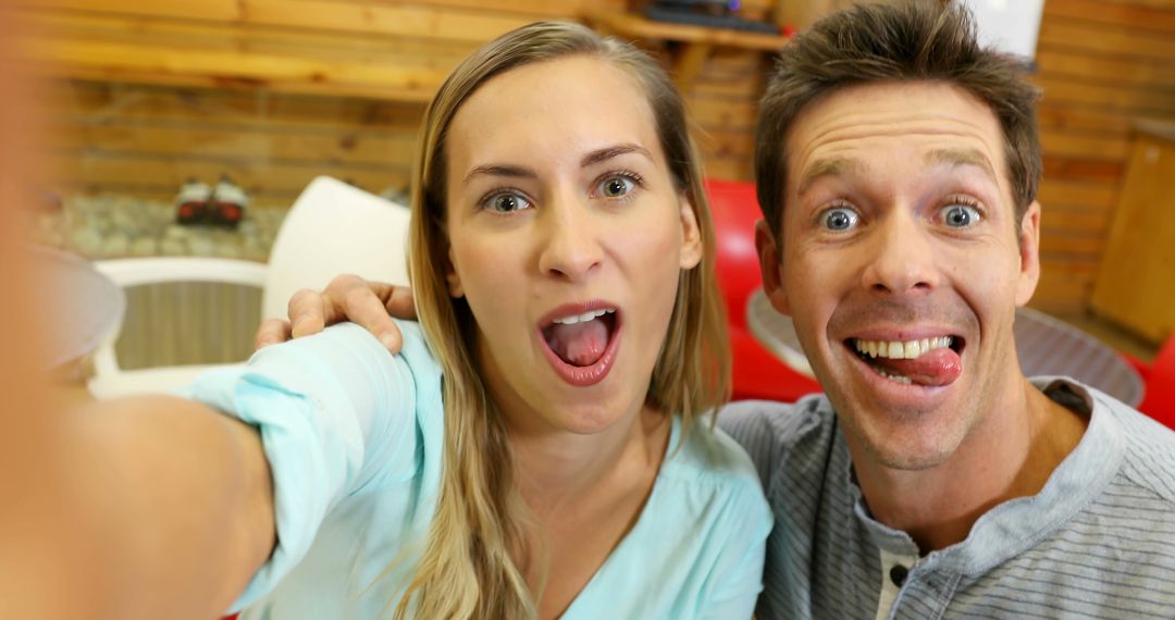 Happy Couple Making Funny Faces While Taking Selfie Indoors - Free Images, Stock Photos and Pictures on Pikwizard.com