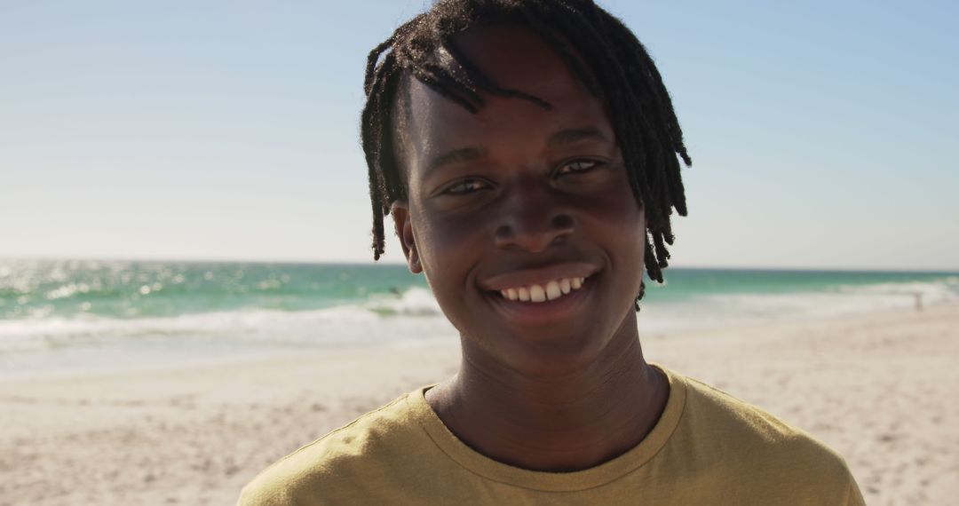 Smiling Teenage Boy on Sunny Beach Day - Free Images, Stock Photos and Pictures on Pikwizard.com