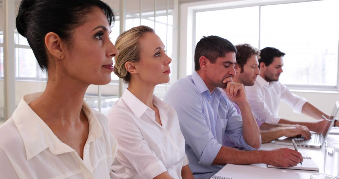 Diverse Team Focusing in Modern Meeting Room Collaboration