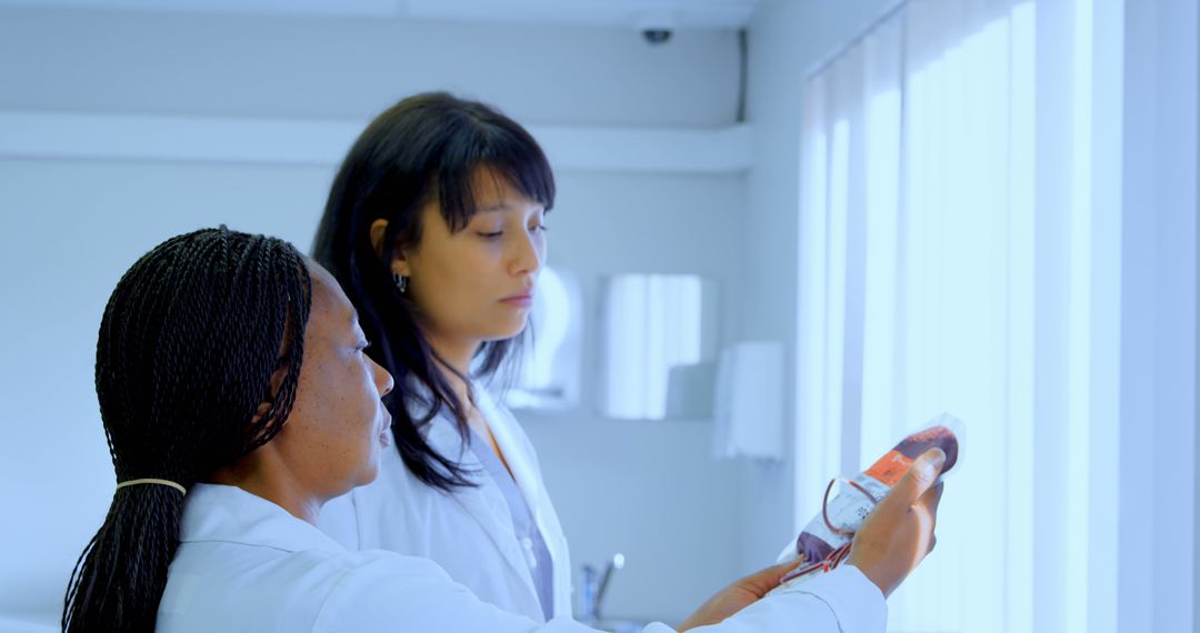 Medical Professionals Examining Blood Sample in Laboratory - Free Images, Stock Photos and Pictures on Pikwizard.com