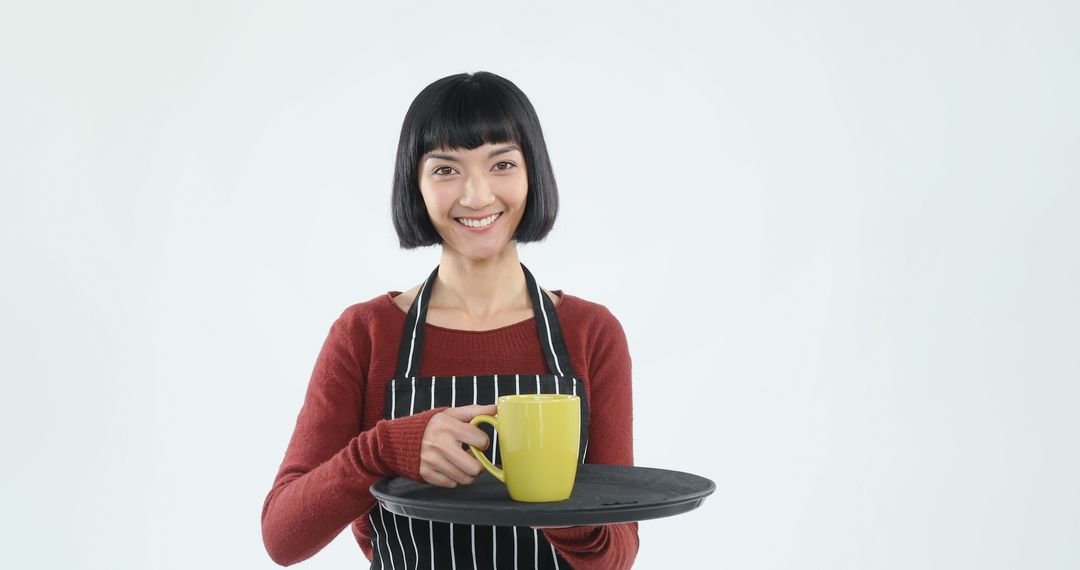 Smiling Woman Holding Tea Cup on Tray with Isolated Background - Free Images, Stock Photos and Pictures on Pikwizard.com