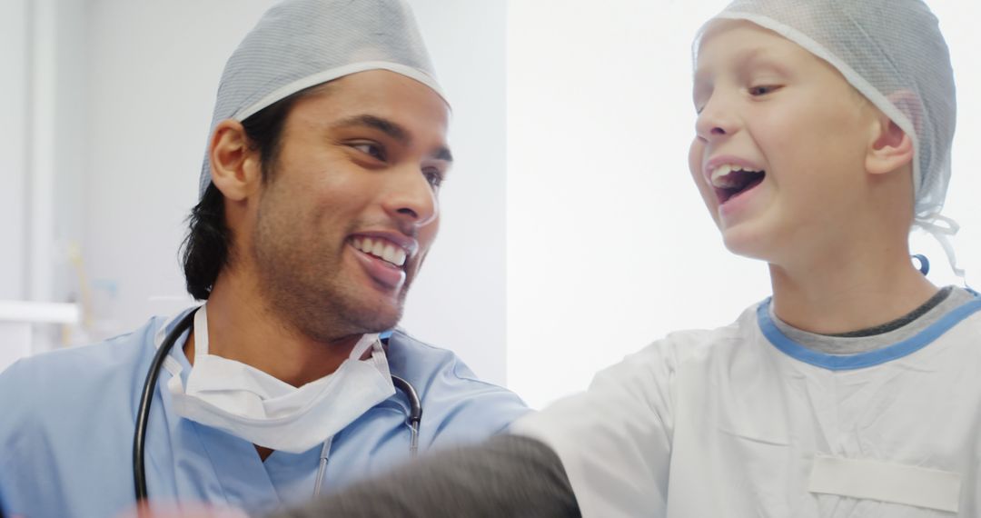 Friendly Doctor and Happy Child Laughing Together - Free Images, Stock Photos and Pictures on Pikwizard.com