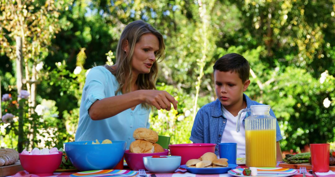 Mother and Son Enjoying Picnic in Garden - Free Images, Stock Photos and Pictures on Pikwizard.com