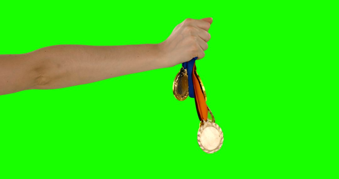 Hand Holding Gold Medals on Green Screen Background - Free Images, Stock Photos and Pictures on Pikwizard.com