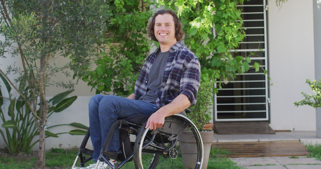 Smiling Young Adult in Wheelchair Enjoying Sunny Day Outdoors - Free Images, Stock Photos and Pictures on Pikwizard.com