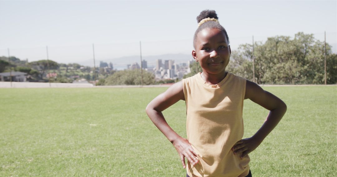 Smiling Young African Girl on Sunny Field Enjoying Summer Day