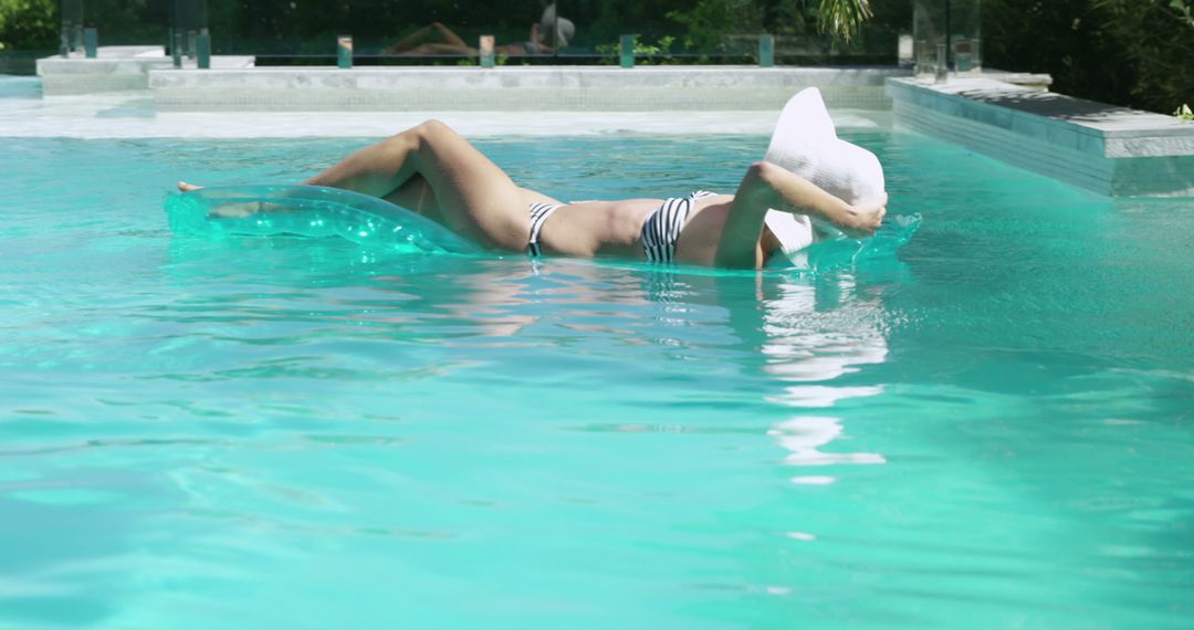 Woman Relaxing on Inflatable Pool Float near Resort - Free Images, Stock Photos and Pictures on Pikwizard.com