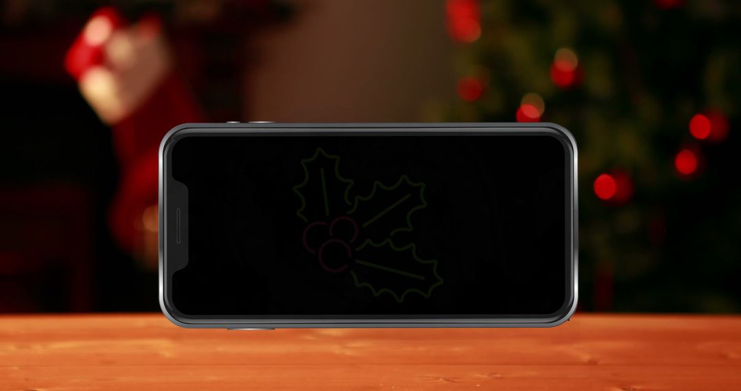 Smartphone Displaying Festive Leaves in Christmas Setting