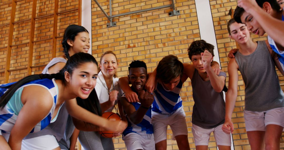 Diverse Teen Basketball Team Embracing for Unity and Sportsmanship