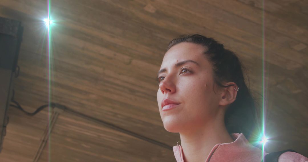 Woman Contemplating Under Studio Lights in Industrial Setting