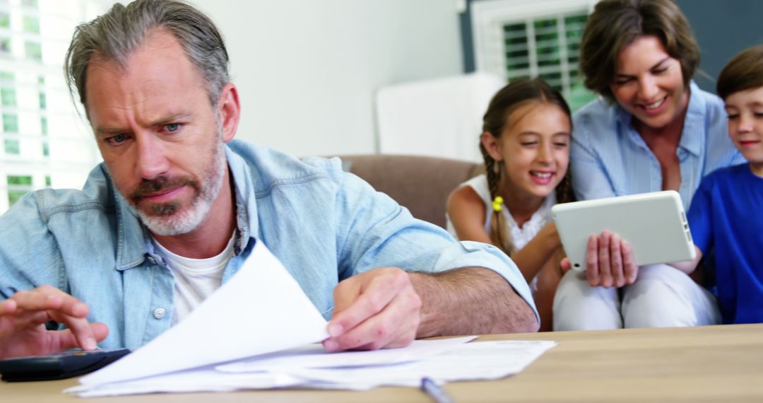 Stressed Father Calculating Household Expenses