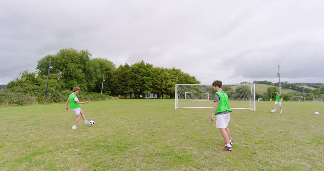 Teenage Soccer Players Practicing on Open Field
