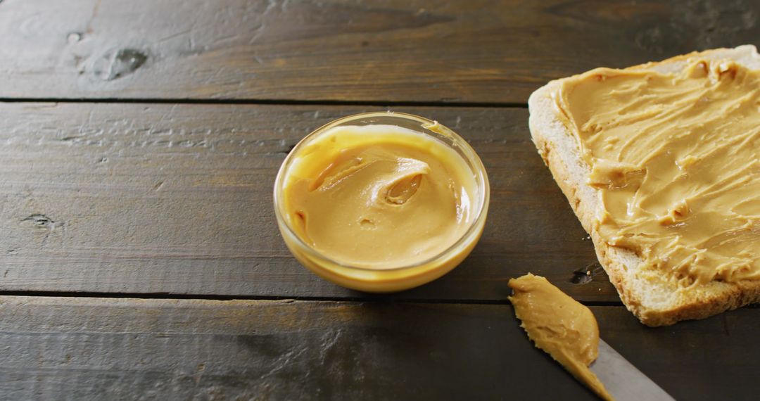 Peanut Butter Spread on Toast with Wooden Table Background