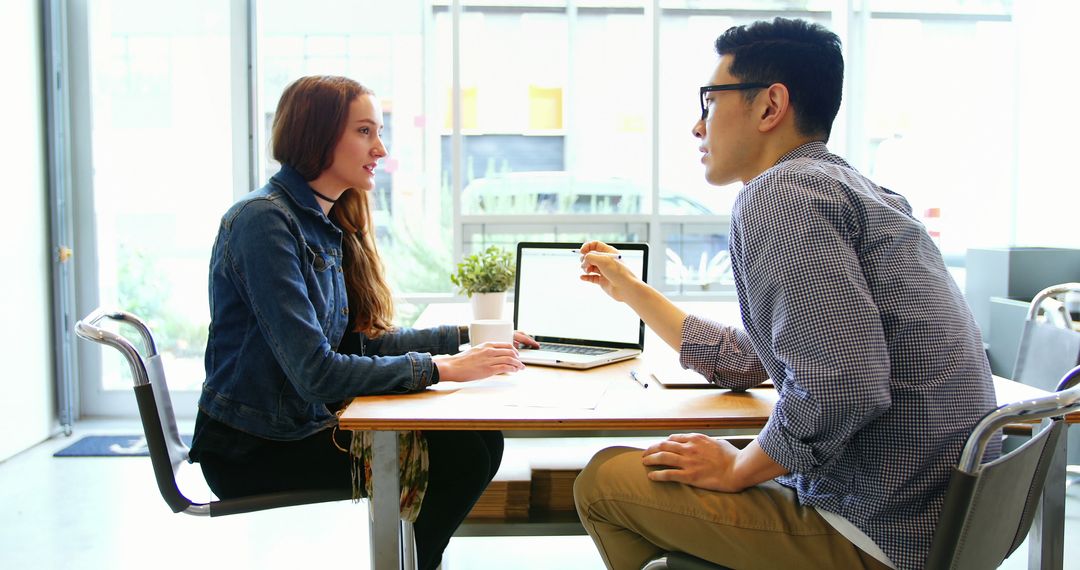 Colleagues Engaging in Professional Discussion in Modern Office