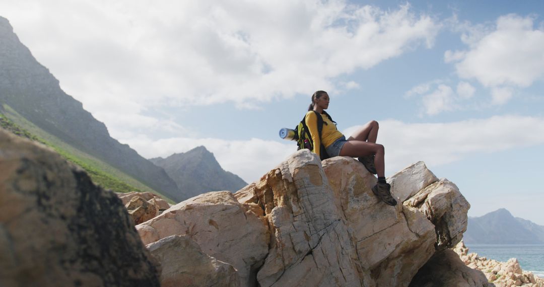 Hiker Enjoying Scenic Mountain View on Sunny Day