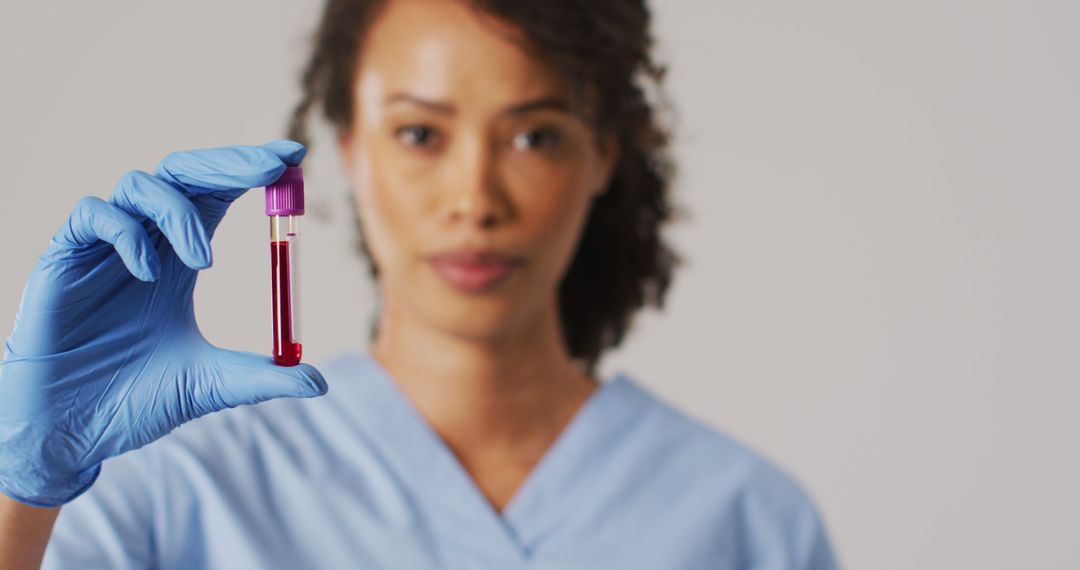 Young Nurse Holding Blood Sample in Laboratory - Free Images, Stock Photos and Pictures on Pikwizard.com