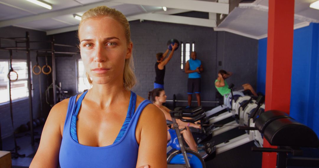 Confident Female Trainer Overseeing Gym Workout Session - Free Images, Stock Photos and Pictures on Pikwizard.com