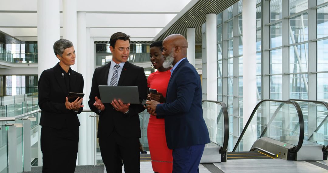 Diverse Business Team Discussing Corporate Strategy in Modern Lobby